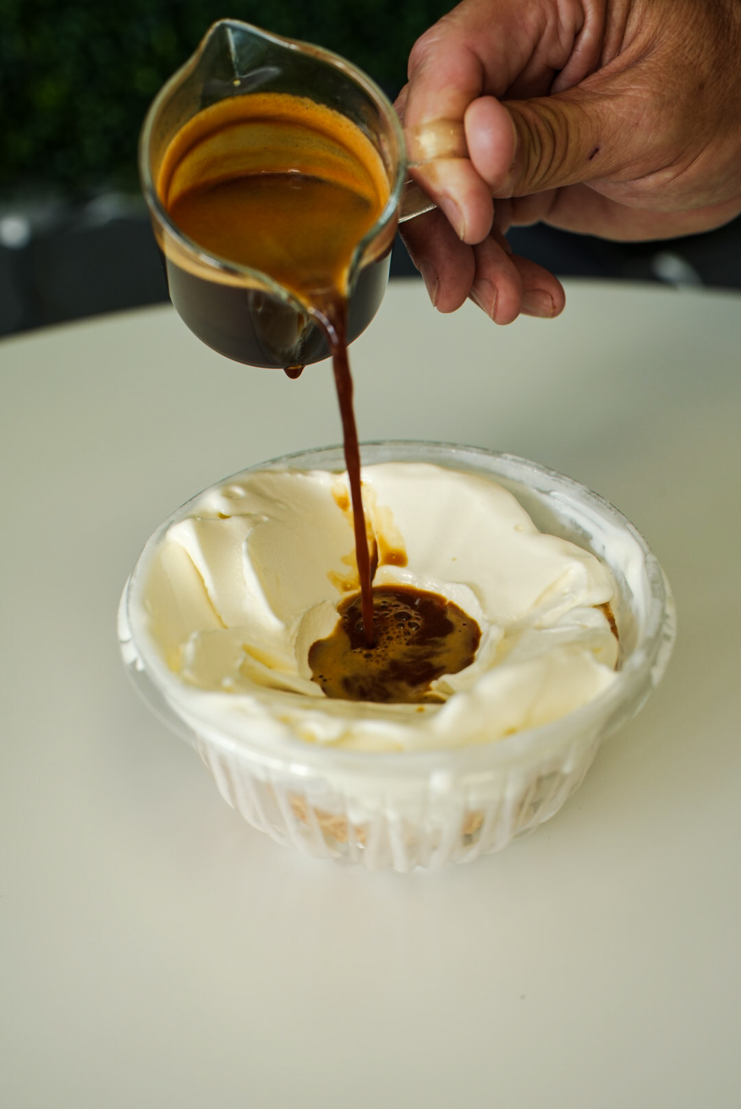 Espresso poured over ice cream for an affogato